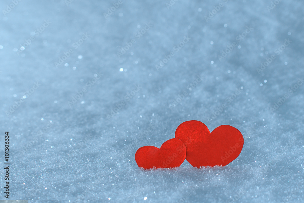 Red paper hearts in the snow. Greeting card for Valentine's Day.