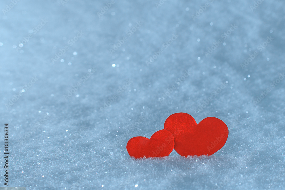 Fototapeta premium Red paper hearts in the snow. Greeting card for Valentine's Day.