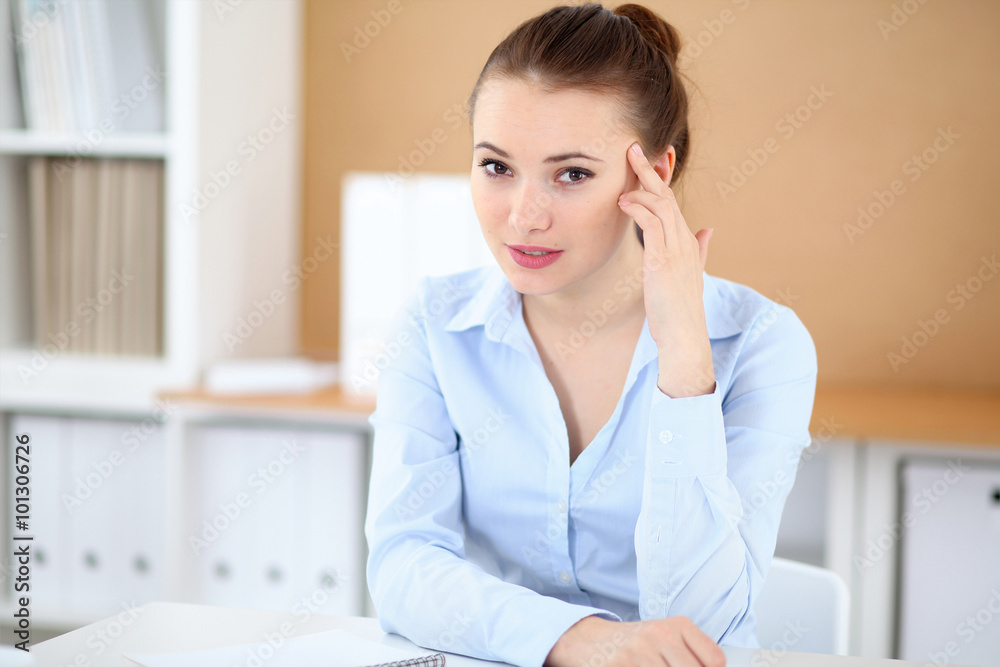 Young business woman working on laptop in office. Successful business concept. Young business woman working on laptop in office. Successful business concept.