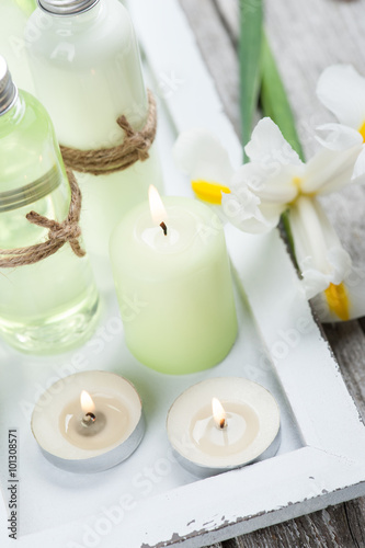 Bath products, candles, wooden background