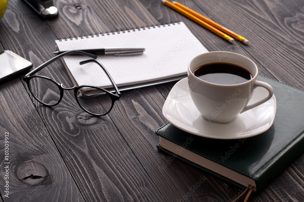 cup of coffee with notebook and glasses