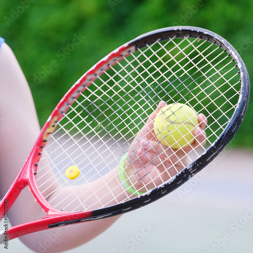 Tennis racket in girl's hand