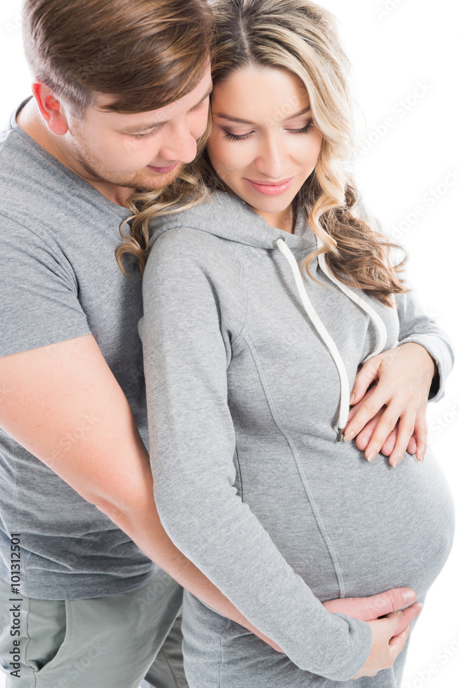 Husband and pregnant wife hugging each other Husband and pregnant wife hugging each other
