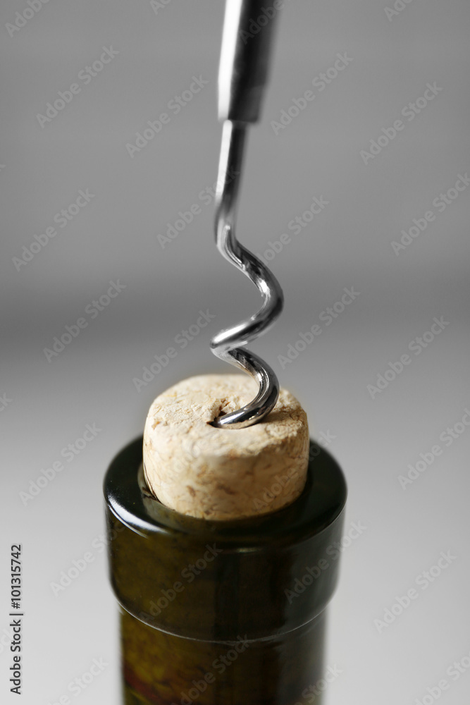 Opening bottle of wine on a light background Opening bottle of wine on a light background