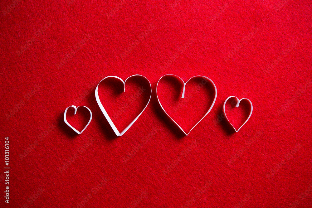 Paper hearts on red background for gift on valentines day.