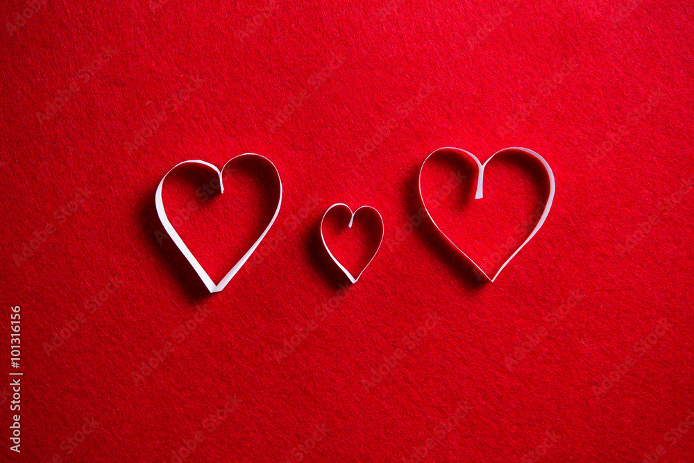 Paper hearts on red background for gift on valentines day.