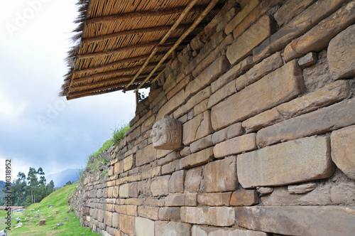 Stone mask on the ancient temple, Chavin de Huantar in Peru photo