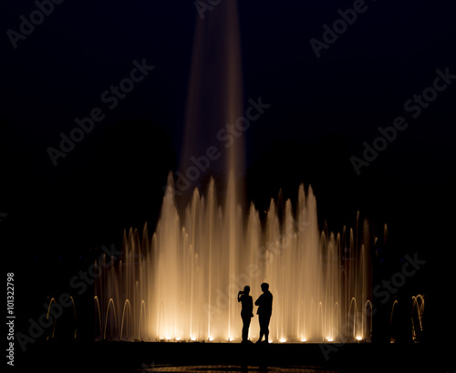 Romance abstract background, Couples take a photograph with fountain at night.