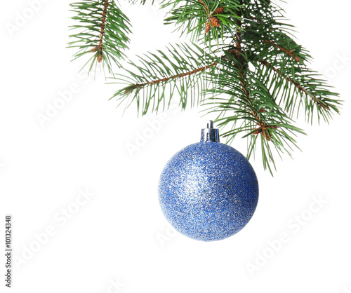 Christmas blue bauble on a fir branch, isolated on white