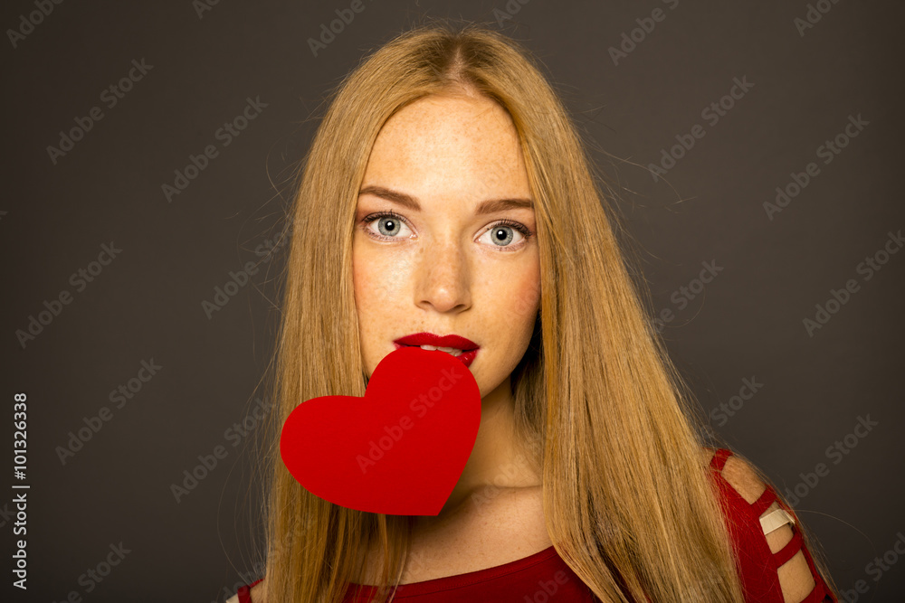 Portrait of Beautiful gorgeous woman with glamour bright makeup and red heart in hand Portrait of Beautiful gorgeous woman with glamour bright makeup and red heart in hand