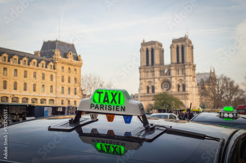 Parisien taxi with Notre Dame cathedral