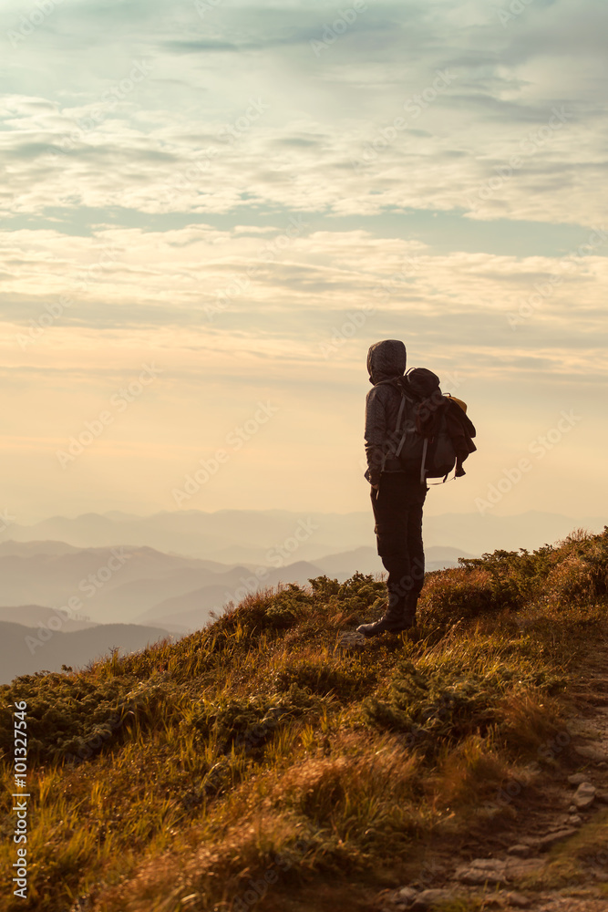 Traveler with backpack and mountain panorama Traveler with backpack and mountain panorama