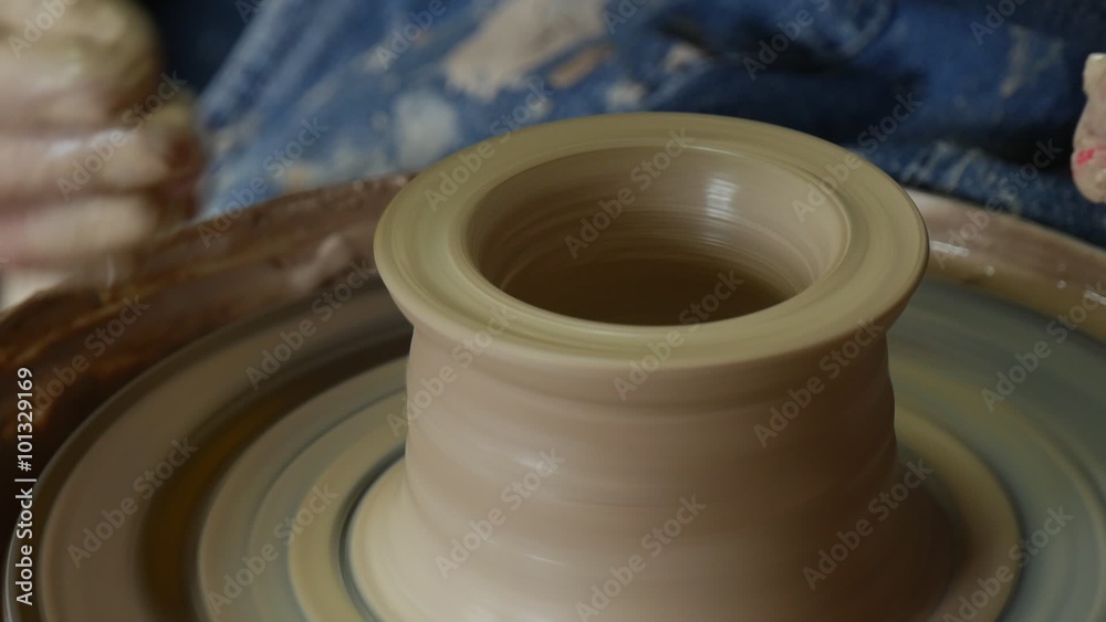 Potter Craftsman is Teaching a Woman to Work on Pottery Wheel Holding Her Hand Showing How to Mould a Clay Pot Making a Vessel Male and Female Hands Potter Craftsman is Teaching a Woman to Work on Pottery Wheel Holding Her Hand Showing How to Mould a Clay Pot Making a Vessel Male and Female Hands