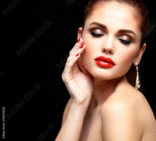 Beauty Model Woman with Long Brown Wavy Hair. Healthy Hair and Beautiful Professional Makeup. Red Lips and Smoky Eyes Make up. Gorgeous Glamour Lady Portrait. Haircare  Skincare concept