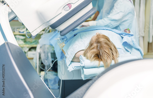 A female patient on a cath lab table durring catheterisation