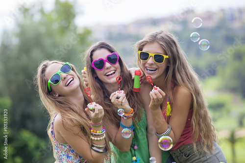 Vászonkép teen girls blowing bubbles