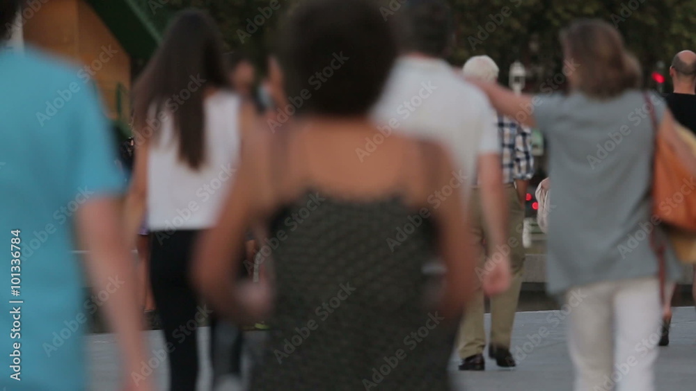 People of various ages and gender walking in busy city square. Anonymous crowd