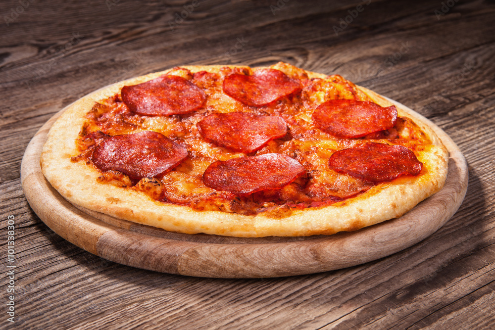 Pizza with salami on the old board Pizza with salami on the old board