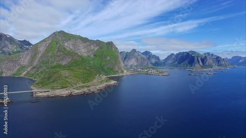 Aerial footage of Lofoten islands coastline with scenic road leading from Reine, popular tourist destination. Aerial 4k Ultra HD.