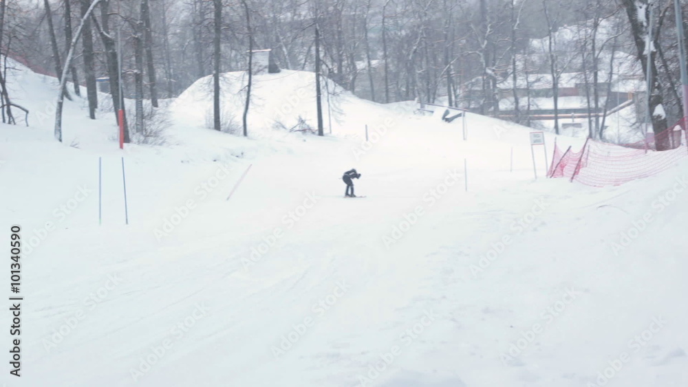 Close-up skier skiing downhill in forest Close-up skier skiing downhill in forest