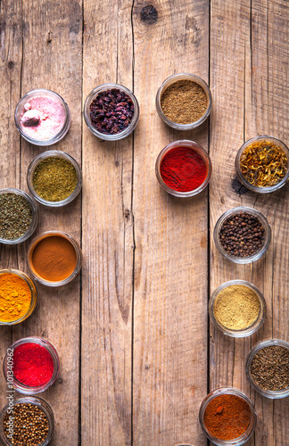 Spices in jars on wooden background. Food