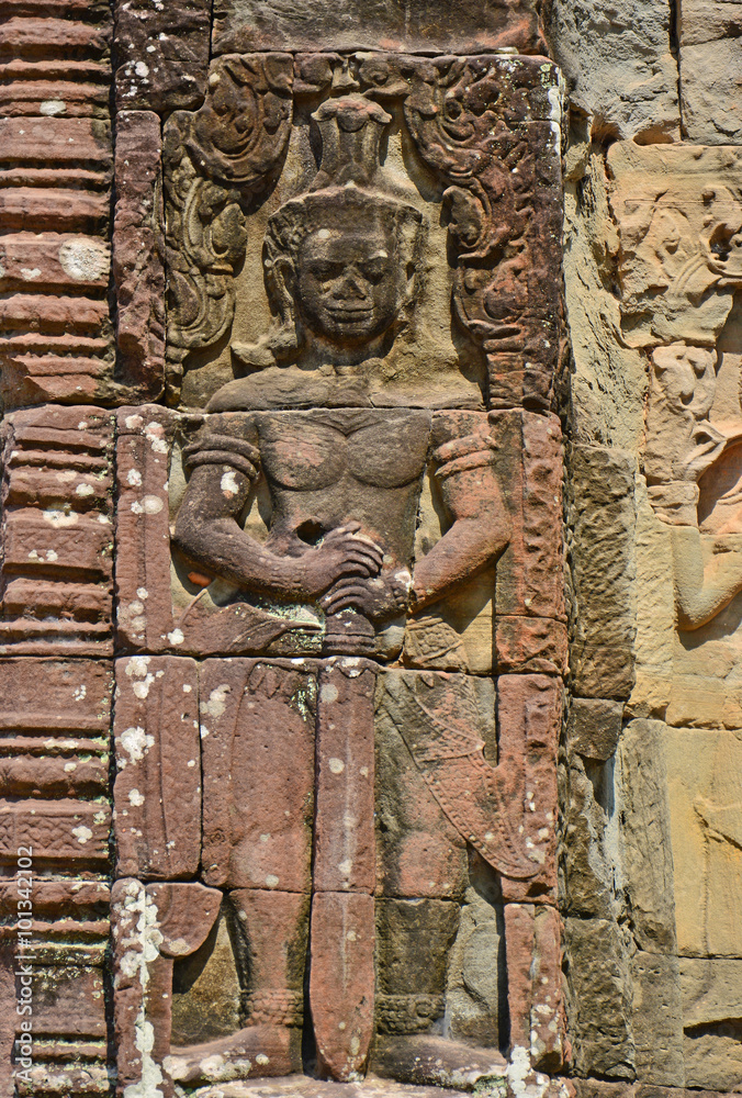unique carving of khmer dvarapala stands guard asparas found on the wall temple ruins of angkor wat, Siem Reap, Cambodia.
