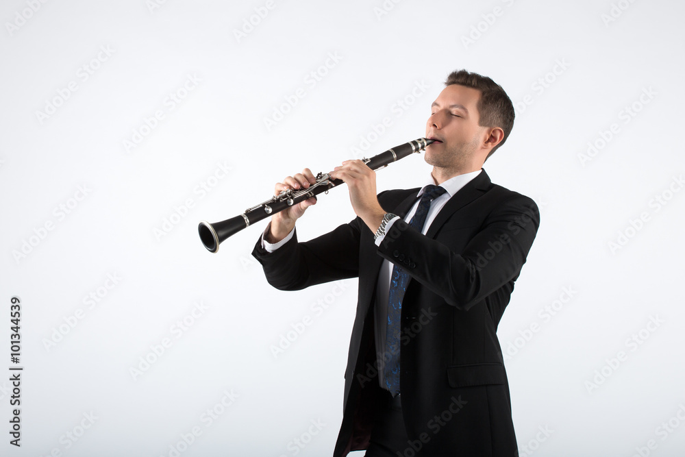 Naklejka premium Young man playing the clarinet