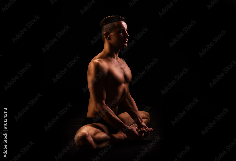 young man doing yoga and gymnastics, posture butterfly young man doing yoga and gymnastics, posture butterfly