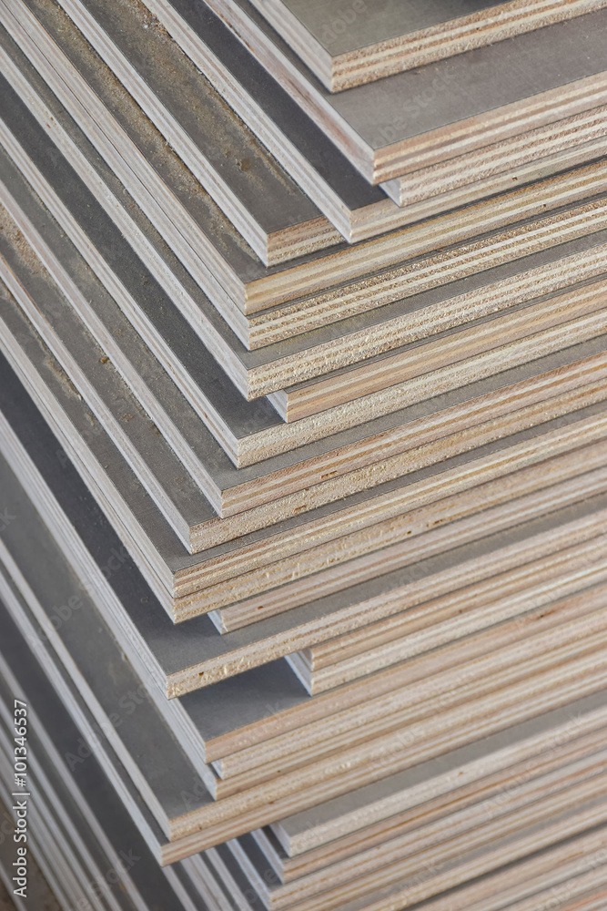 Stack of industrial plywood in construction site for background