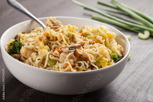 Chinese chicken lo mein with cabbage, carrots, celery, mushrooms, turnips, broccoli, and assorted vegetables horizontal shot