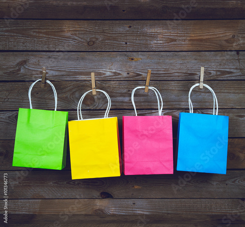 multicolored Shopping bags on a wooden background, sale, purchase