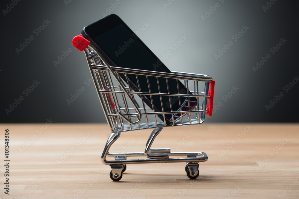 Smartphone In Shopping Cart On Table