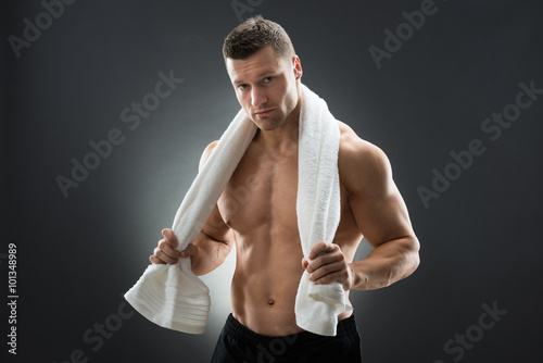 Muscular Man Holding Towel Around Neck