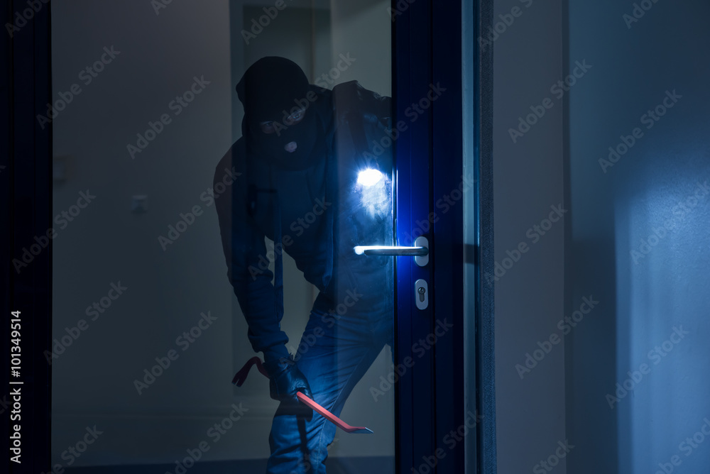Thief With Flashlight Trying To Break Door Thief With Flashlight Trying To Break Door