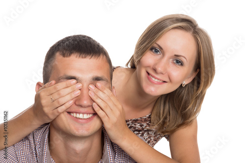 Girl with her hands covering his eyes guy