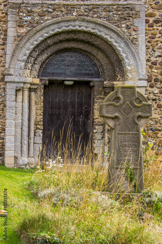 Ancient church door made of wood with celtic cross headstone