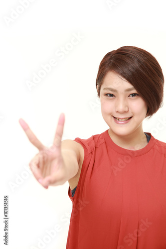 young Japanese woman showing a victory sign