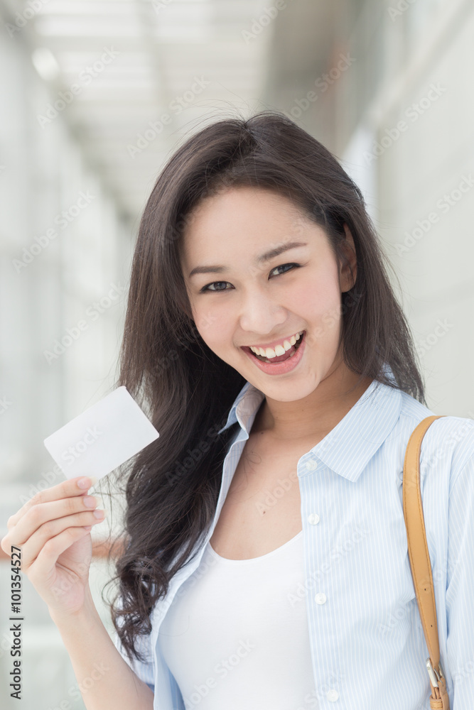 Asian woman holding a card in her hand