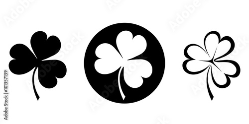 Set of three black silhouettes of clovers (shamrock). Vector illustration.