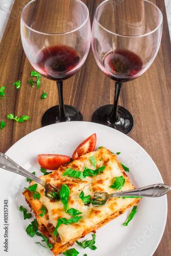 Dinner for two! - Traditional italian meal - lasagna with bolognese sauce and red wine.