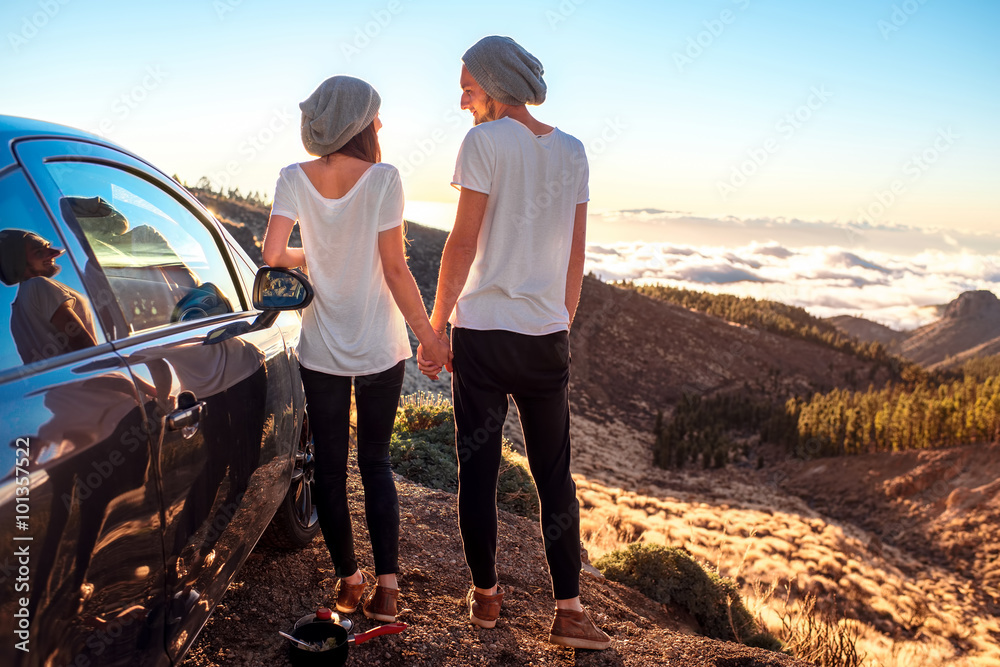 Couple standing together near the car Couple standing together near the car