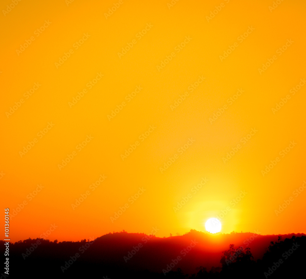Background of colorful sunset with sun on the mountain.