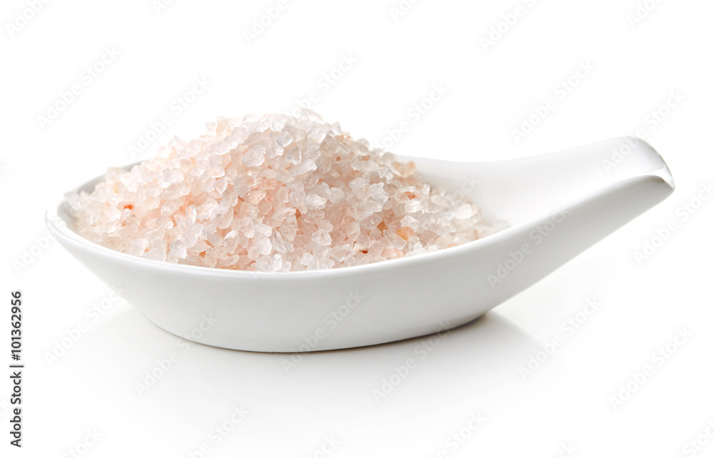Himalayan salt in white porcelain spoon Himalayan salt in white porcelain spoon