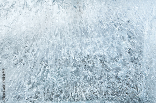 Glacial transparent wall of ice with patterns. © wildman