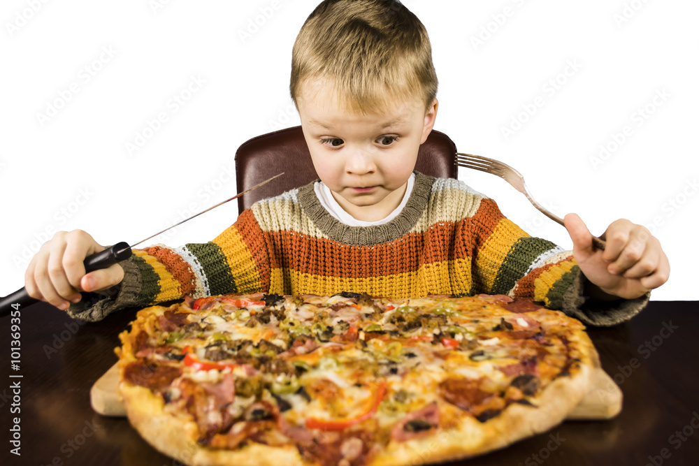 boy eating a large pizza