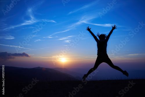 Silhouette of jumping young woman