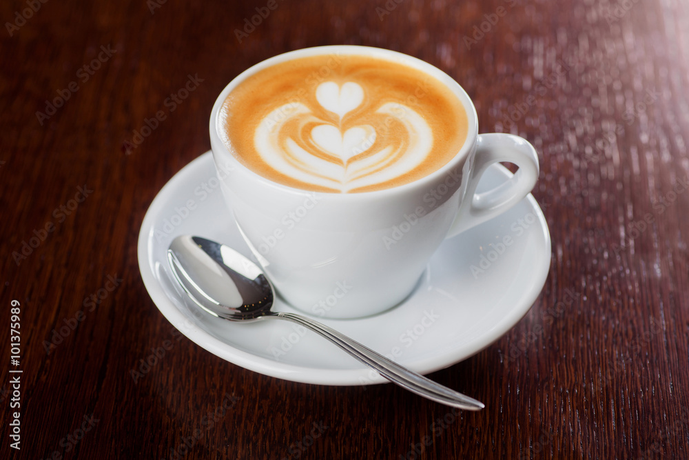 Cup of coffee with professional latte-art on wooden table. Shalow dof. Cup of coffee with professional latte-art on wooden table. Shalow dof.