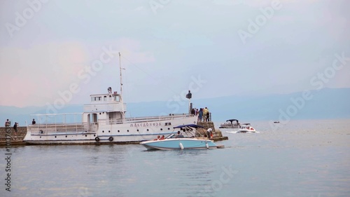 OHRID, MACEDONIA, JUNE 2015: Ships traveling at the Ohrid lake. Ohrid is famous for its unesco listed historical center and beautiful lake separating Macedonia from Albania.