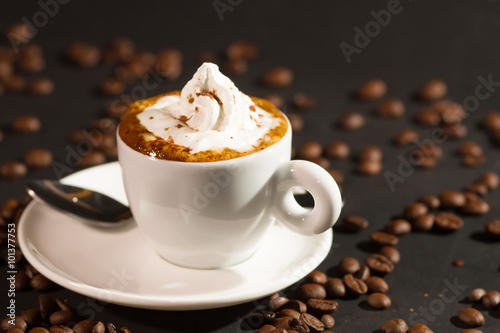 Fototapeta Naklejka Na Ścianę i Meble -  cup of coffee and coffee beans over dark background