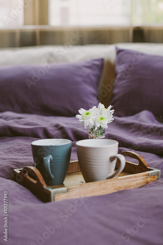 Two cups with morning coffee and flowers
